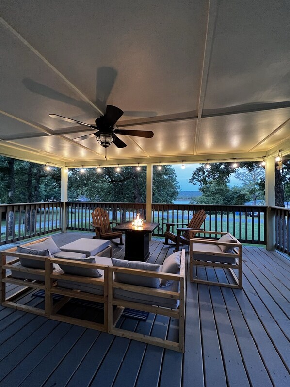 Enjoy the front porch with amazing lake views and propane fire pit!