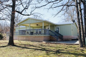 Front of house with large covered porch with amazing view of Lake Eufaula. 