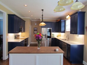 Kitchen with Keurig, microwave, dishwasher, stovetop/oven