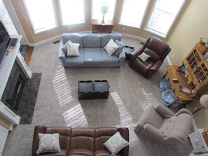 Living room, reclining couch and chairs and view of backyard.