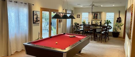 Pool table has its own light and fan to keep the fun going. 