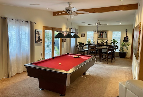 Pool table has its own light and fan to keep the fun going. 