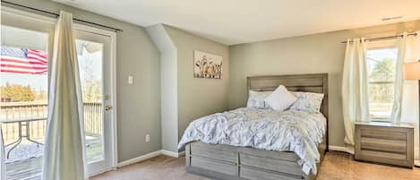 Master bedroom with access to a deck overviewing the property
