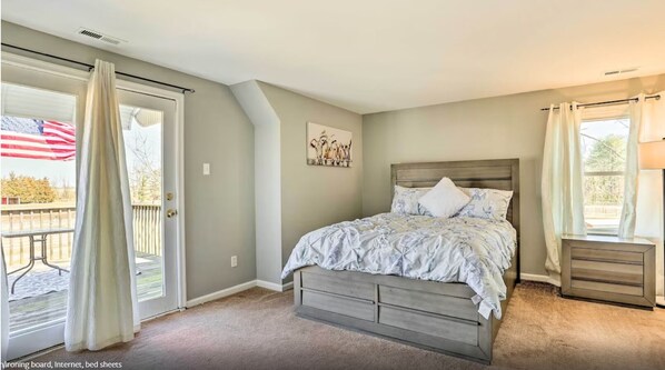 Master bedroom with access to a deck overviewing the property