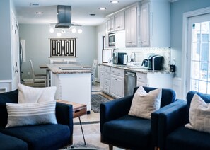 Kitchen seamlessly flows into living area, perfect for entertaining guests.