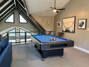 Tournament size pool table with cues for the entire family