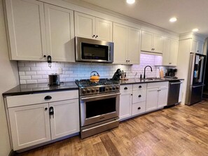 The custom kitchen easily accommodates several cooks and guests, prepping and snacking in style.