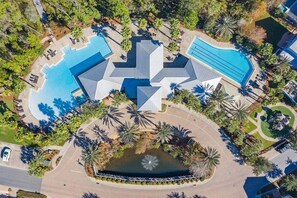 Enjoy stunning aerial views of this resort-style pool area, complete with lush greenery, sparkling water, and plenty of space to soak up the sun.