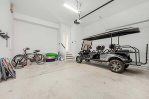 Spacious garage, amazing golf cart and all the toys you will need