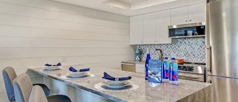 Waterfall Granite Counter with built in refrigerator.