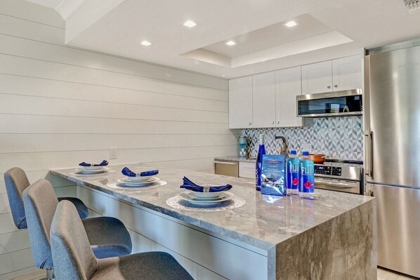 Waterfall Granite Counter with built in refrigerator.