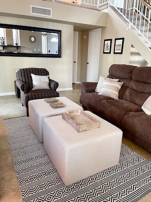 Living room with double reclining couch, TV, and fireplace