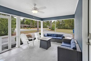 Screened in patio area with gas fire pit