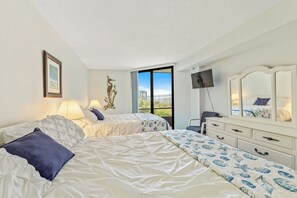 Bedroom offers 2 queen beds and acess to both the ensuite bath, and the patio.