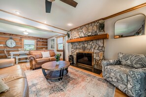 Main level living room with leather sofas and chairs.