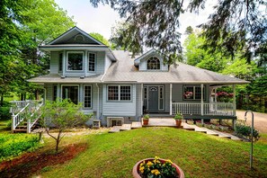 Front view of cottage & lawn in the summer months