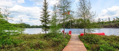 Wooden boardwalk leading to the lake and dock.