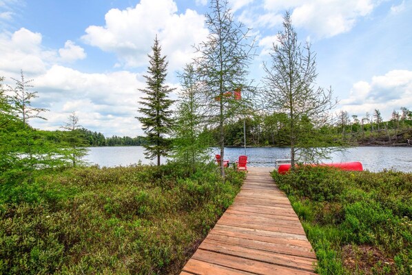 Wooden boardwalk leading to the lake and dock.