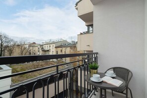 A balcony with seating, offering a charming view of the surrounding area.
