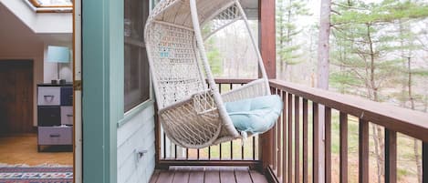 Perch from the upstairs balcony on this cozy swing