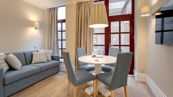 Lovely living area with a cozy sofa and a dining area for 4. #cozy #airbnb