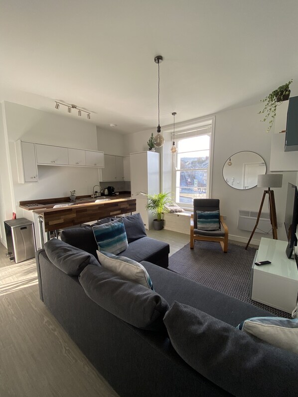 Living room, kitchen and work/breakfast bar.