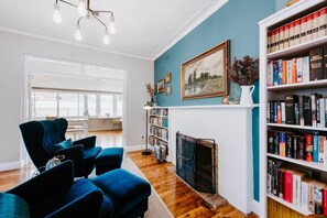 A dedicated seating room allows guests to take a moment for themselves, unwinding with a good book from the library.
