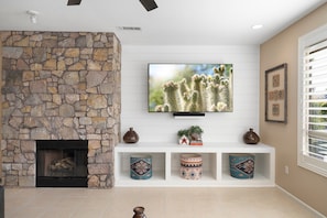 Cozy gas fireplace beside the extra large smart TV with SONOS.