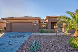 Walk in through the double garage or the gated entry.