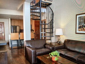 Living Room with view of the staircase leading up to second floor loft.  