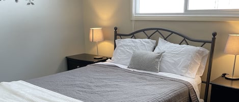 Master bedroom featuring full closet, tall boy and bedside tables.