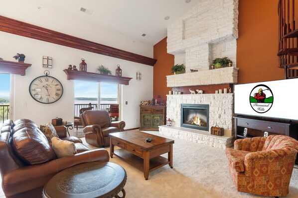 Living Area with Cable TV, Floor to Ceiling Seasonal Fireplace, and Deck Access