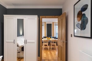 This cosy bedroom features a comfortable double bed with fresh linens, equipped with a wardrobe and blackout roller blinds installed. In addition, the room includes convenient plug points that come with USB and USB C ports for charging your devices.