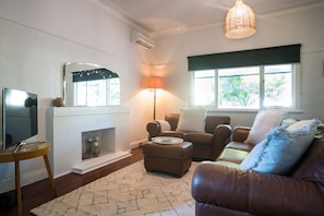 Unwind in the living room, a warm, stylish space with leather sofas, soft lighting, and a great spot for relaxing after a day of exploring.