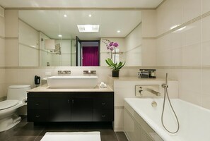 Bathroom with a shower and tub. The essential toiletries and towels are provided