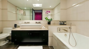 Bathroom with a shower and tub. The essential toiletries and towels are provided