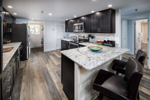Additional bar seating - Pretty counter tops and cabinets make cooking dreamy