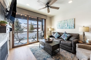 Living area offering mountain views, gas fireplace, and a smart tv.