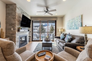 Living area offering mountain views, gas fireplace, and a smart tv.