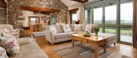 East Lodge - double height ceilings, feature beams and stone detailing throughout the living areas