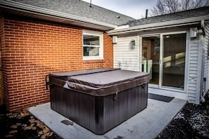 Enjoy a relaxing soak in the large hot tub nestled away in the backyard, directly off of the mudroom.  Outdoor speakers complete the space as guests can listen to their favorite music. 