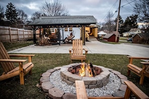 Cozy up by the fire pit with starter firewood provided. 