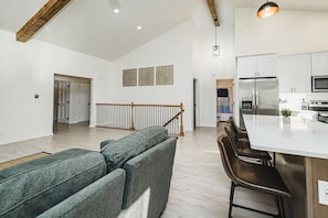 Living Room overseeing the kitchen and dining area with amazing lake views