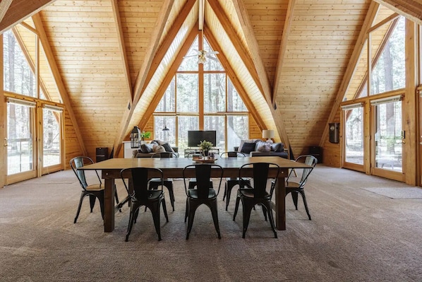 Large dining table to gather for family dinners and game nights! Cathedral ceilings with triple a-frame windows.