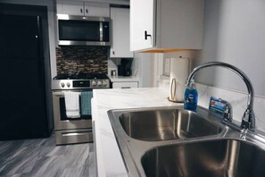 Full Kitchen w/ all the cooking necessities you would need for a comfortable stay