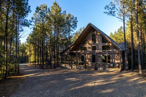As you pull in the circular drive at Maxwell House Cabin,   you'll find plenty of room for your boat, cars, and ATVs. At one end there is a fast charging outlet where you can plug in your EV with your provided charger.