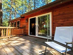 Enjoy nature from the private deck with an outdoor table, chairs, umbrella, and a BBQ.