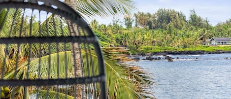 Relax in the swinging chairs on the covered deck overlooking Hana Bay.