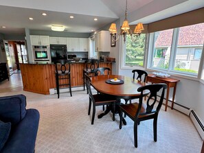 Enjoy a fully stocked kitchen with granite countertops, stainless steel appliances, a Keurig coffee maker, and a breakfast bar that seats 4.