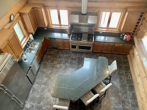 Gourmet kitchen with commercial size gas stove. Granite counters and huge island